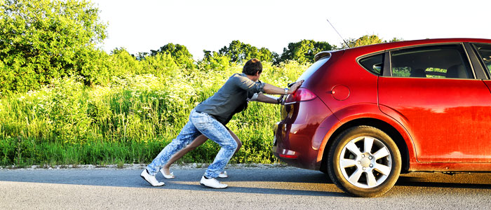 people pushing a car